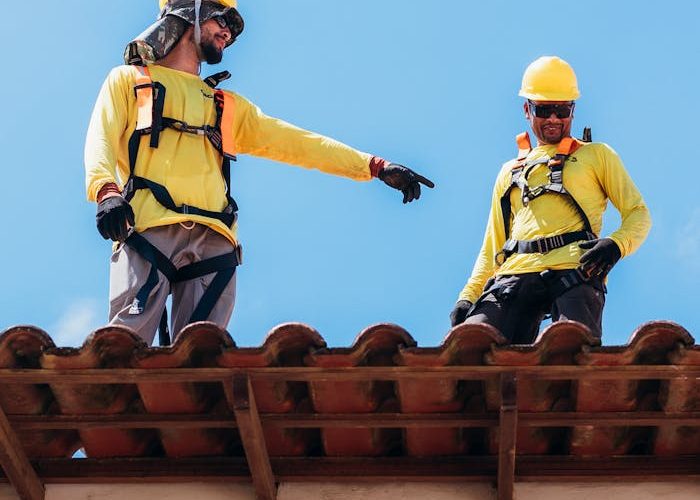 Construction Workers Collaborating on Rooftop